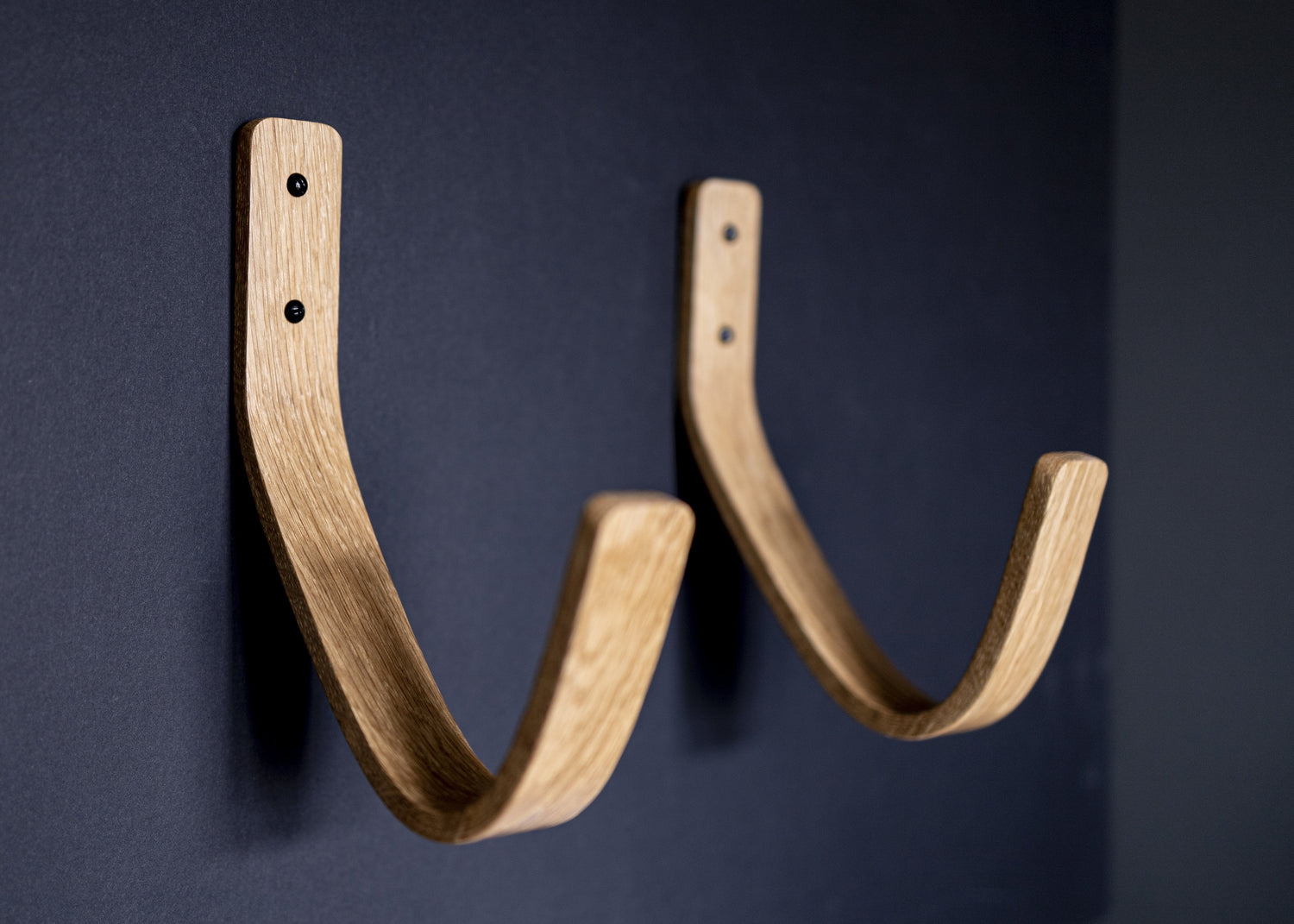 Noir.design surfboard wall mount in solid oak, perfect for hanging longboards, short boards, skies, skate boards and more. Handcrafted in England with a heavy duty design to provide ultimate support and stability.