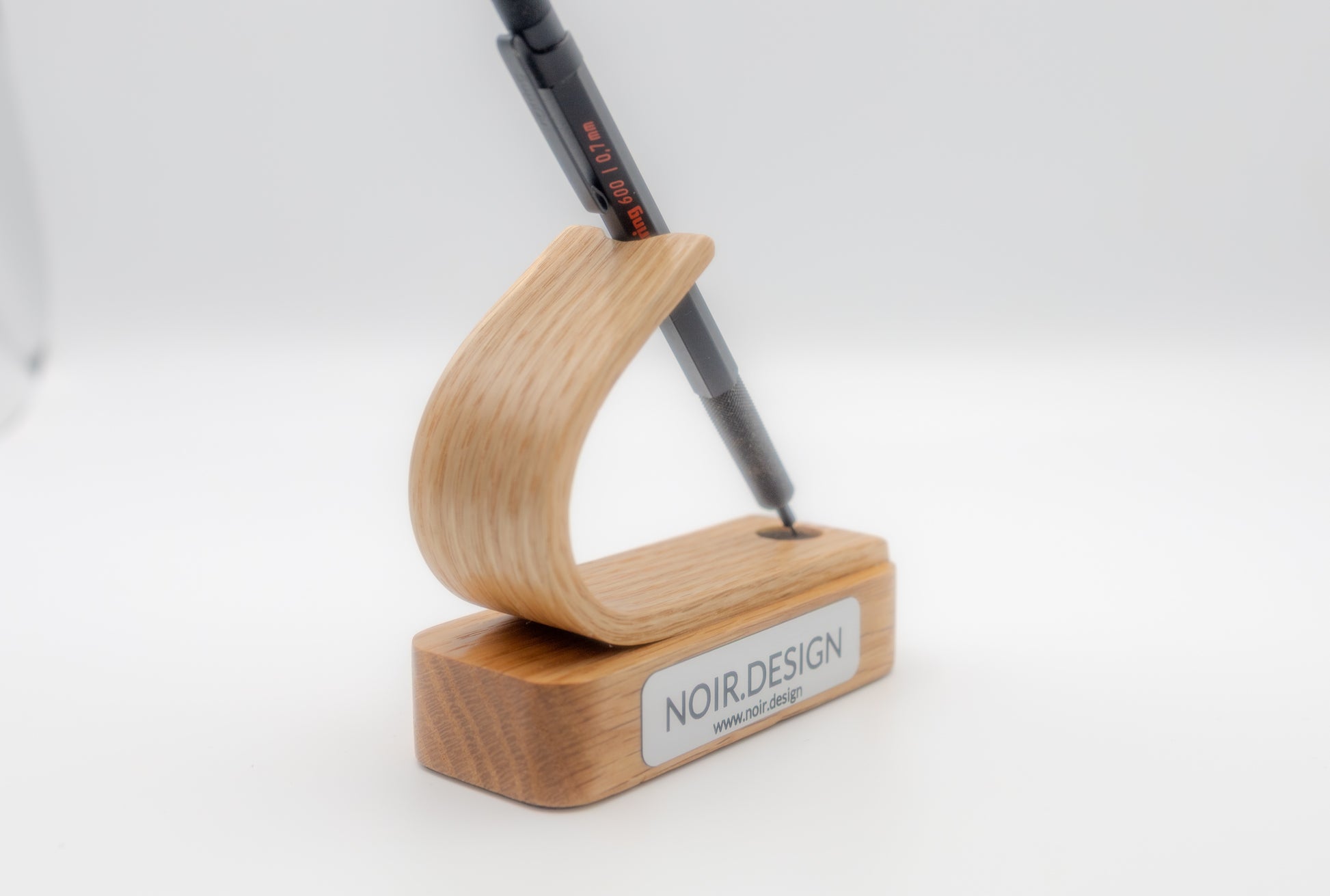 Professional office desk setup with wooden pen holder