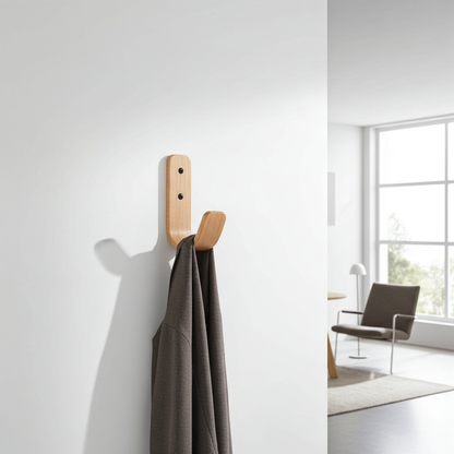 Wooden wall hook with a gray coat in a modern room.